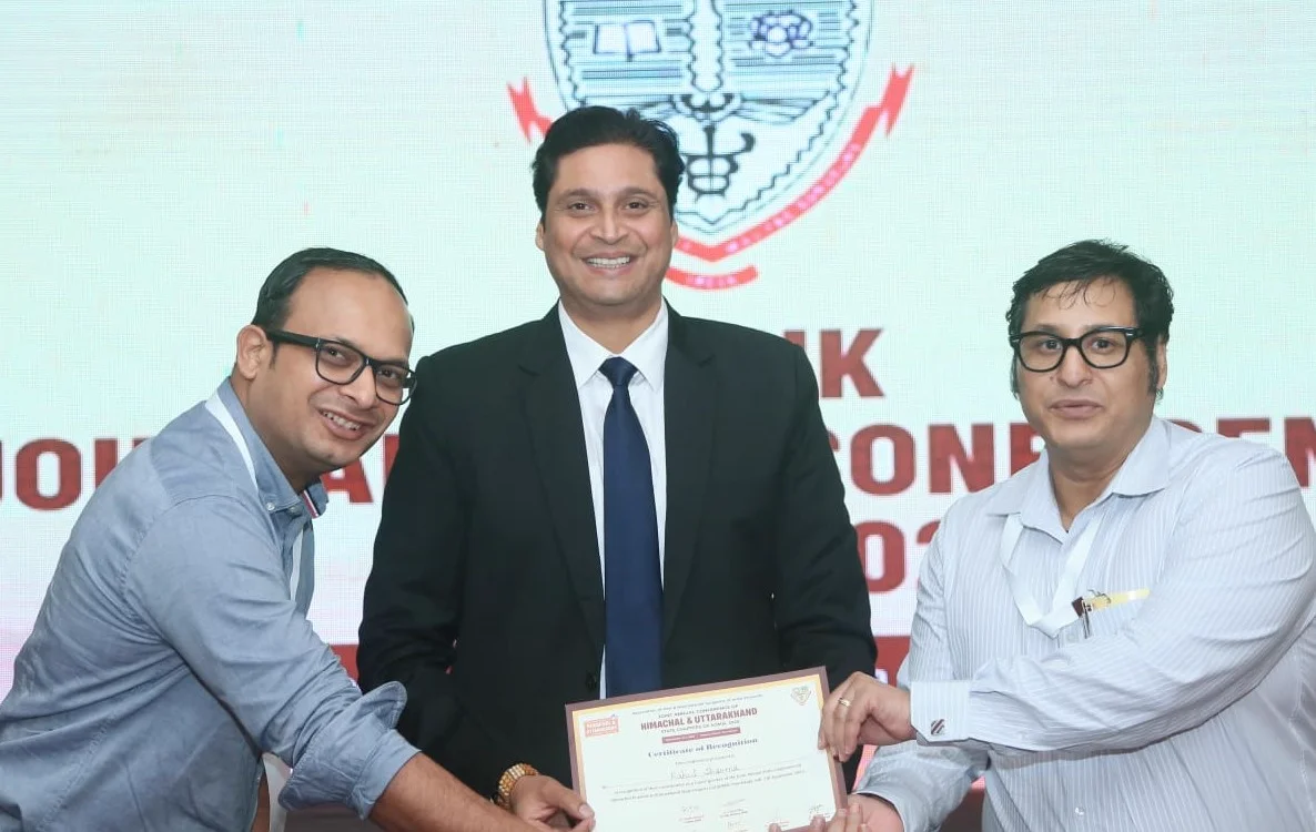 Dr. Rahul Sharma receiving a certificate of recognition